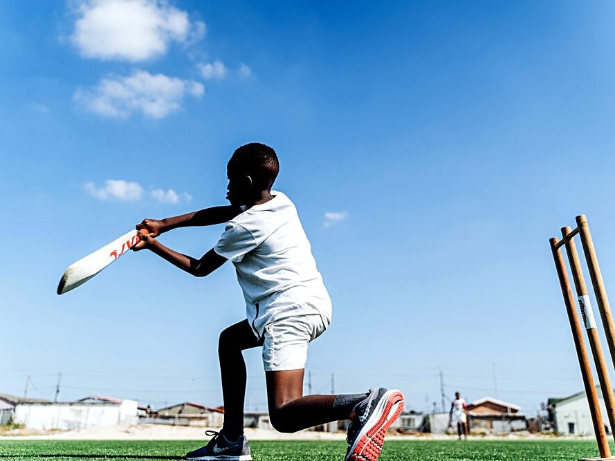 A young batter playing township cricket